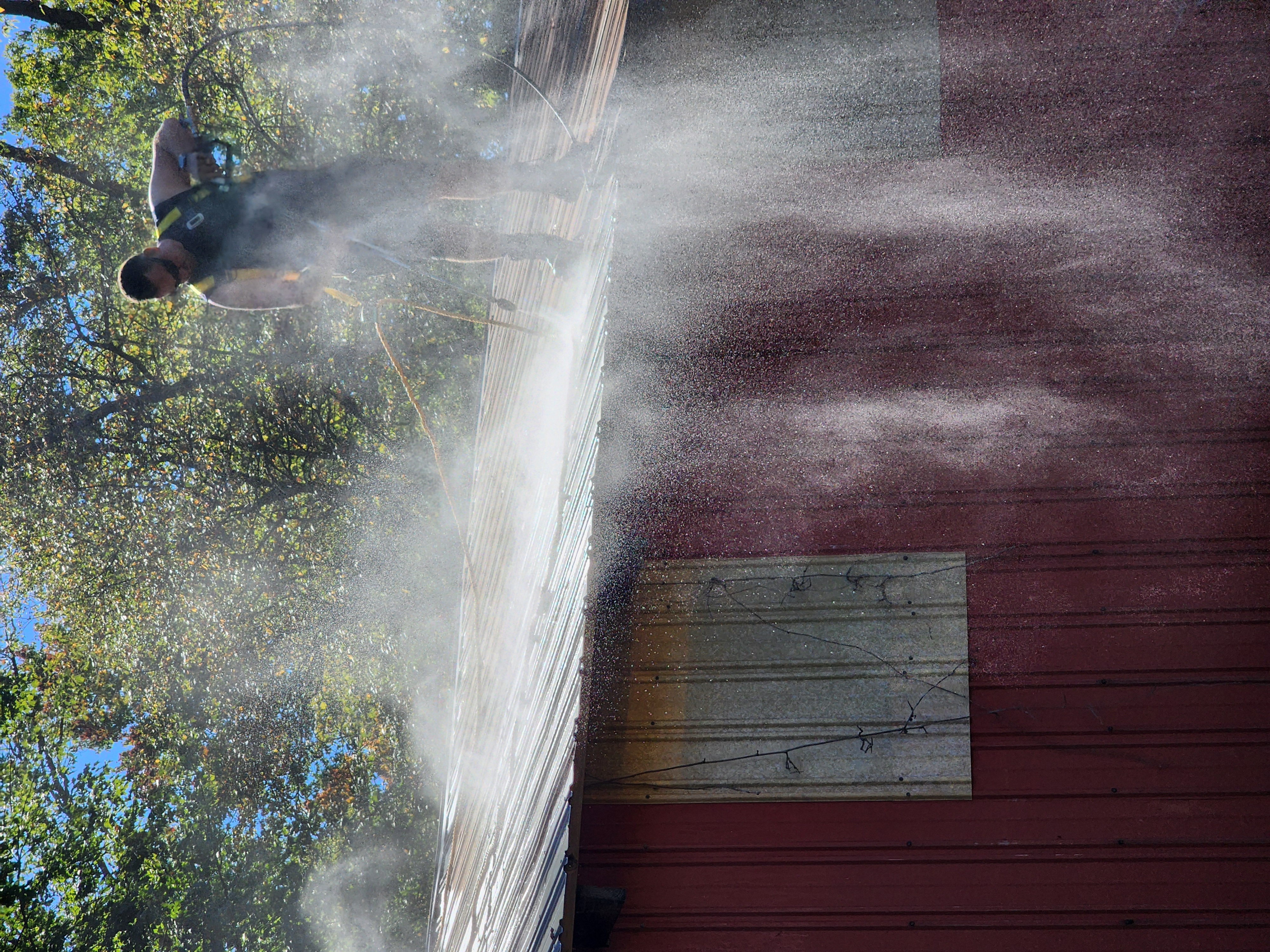 Scott pressure washing a barn roof - Express Paint & Pressure Washing