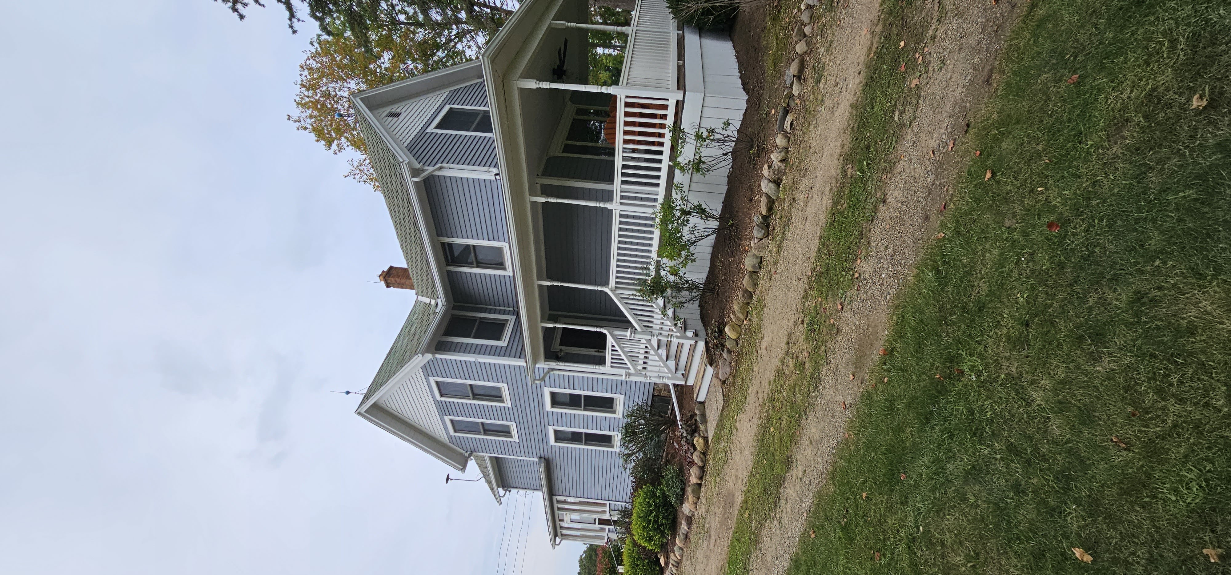 Farmhouse exterior after painting - fresh blue paint
