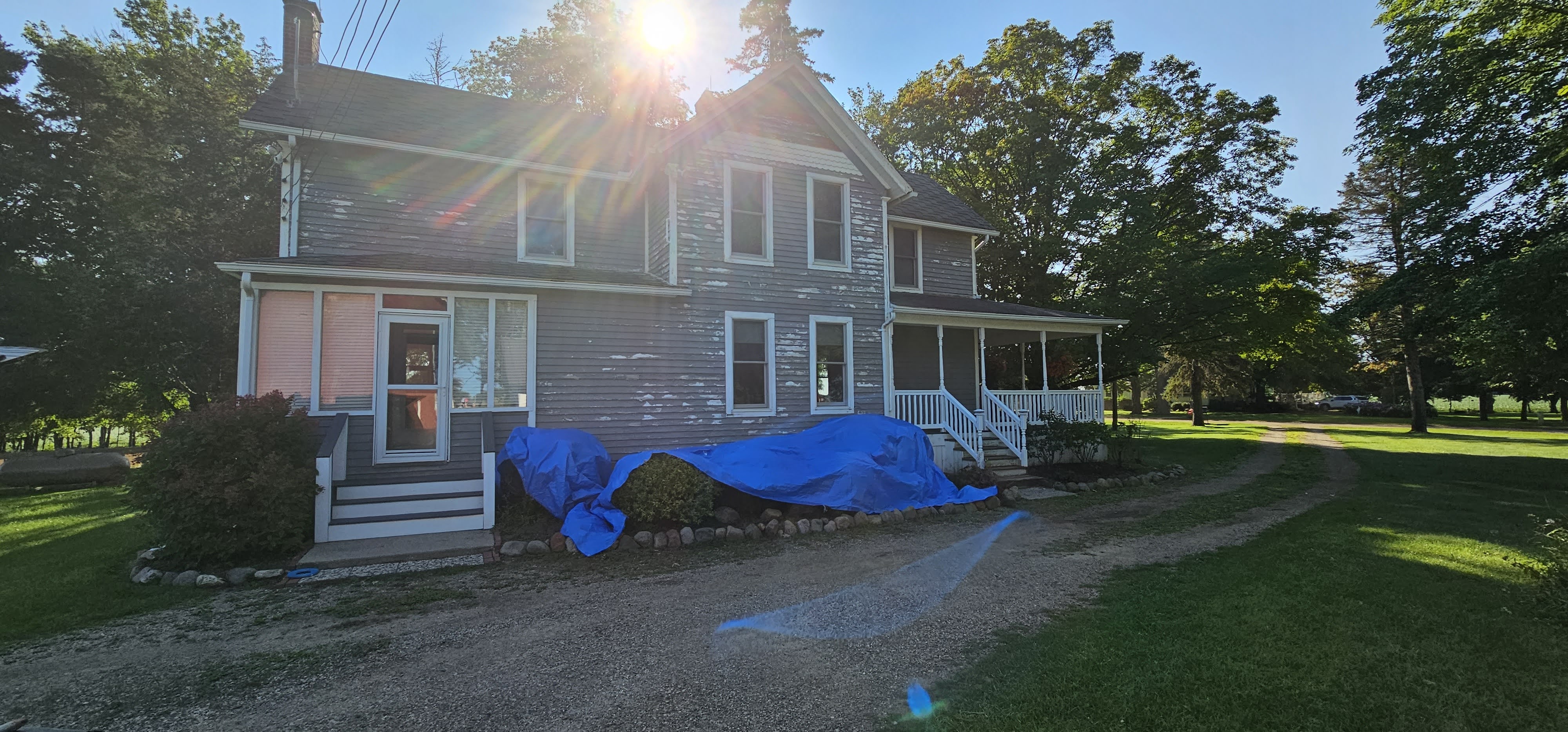 Farmhouse exterior before painting - peeling paint